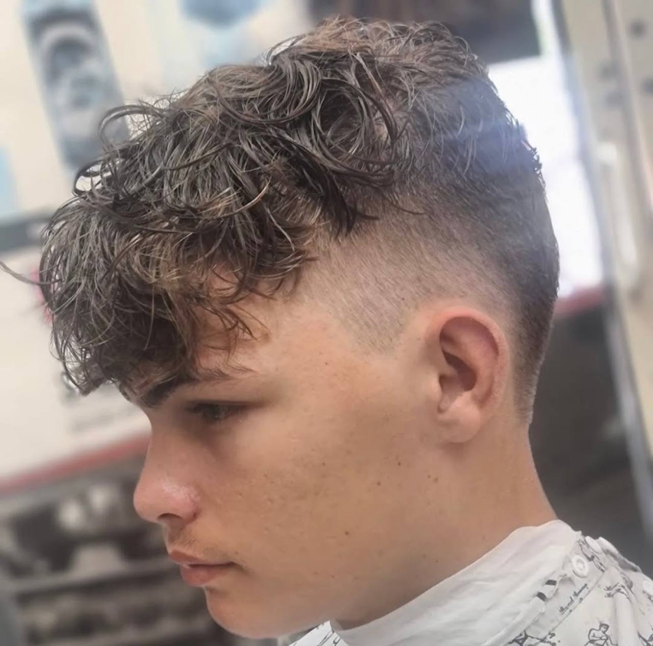 Fresh skin fade with curls at Tim's Classic Cuts